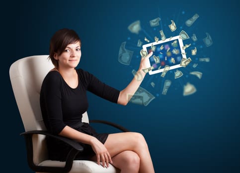 beautiful young woman holding tablet with money