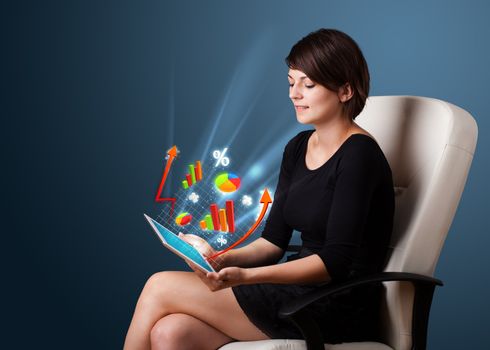 Young business woman looking at modern tablet with abstract lights and various diagrams