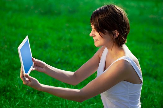 Young business woman looking at modern tablet 