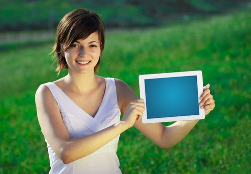 Young business woman looking at modern tablet 