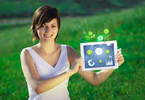 Young business woman looking at modern tablet with abstract light and various diagrams