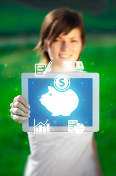 Young business woman looking at modern tablet with abstract light and various diagrams