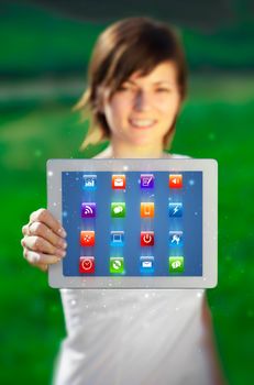 Young business woman looking at modern tablet with abstract lights and various icons