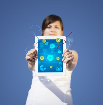 Young business woman looking at modern tablet with abstract light and various diagrams