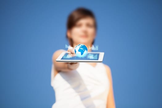 Young business woman looking at modern tablet with abstract lights and globe