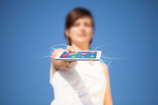 Young business woman looking at modern tablet with abstract lights and various icons