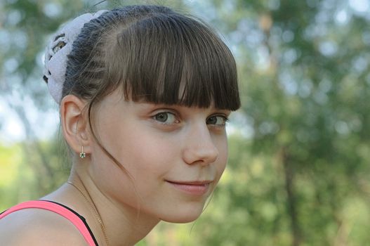 Portrait of young beautiful attractive girl at summer green park. 