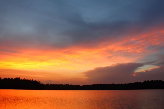Brilliant colors of sunset over a northwoods Wisconsin Lake.