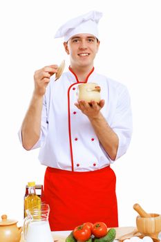 Young cook preparing food wearing a red apron