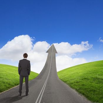 Concept of the road to success with a businessman standing on the road