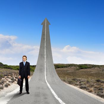 Concept of the road to success with a businessman standing on the road