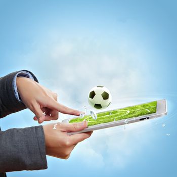 Modern wireless technology illustration with a computer device and football ball