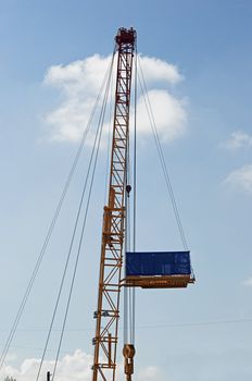 crane with blank banner over blue sky