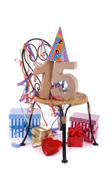 Number of age in a colorful studio setting with paper party hat and figures, a red heart and gifts