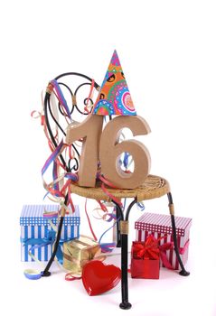 Number of age in a colorful studio setting with paper party hat and figures, a red heart and gifts