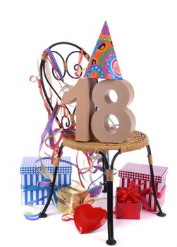 Number of age in a colorful studio setting with paper party hat and figures, a red heart and gifts