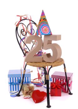 Number of age in a colorful studio setting with paper party hat and figures, a red heart and gifts