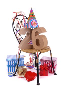 Number of age in a colorful studio setting with paper party hat and figures, a red heart and gifts