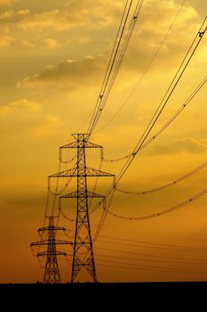 Electric line against sunset sky