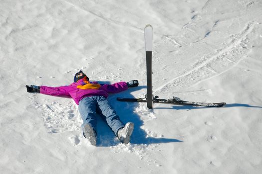 Female skier relaxing in the snow