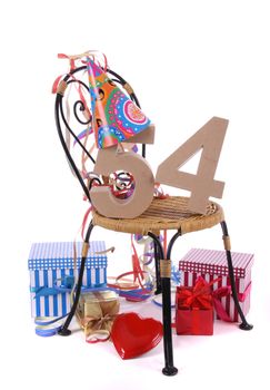 Number of age in a colorful studio setting with paper party hat and figures, a red heart and gifts