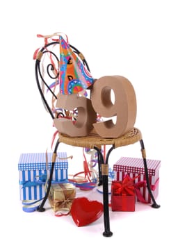 Number of age in a colorful studio setting with paper party hat and figures, a red heart and gifts