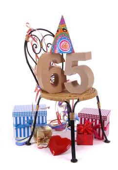 Number of age in a colorful studio setting with paper party hat and figures, a red heart and gifts