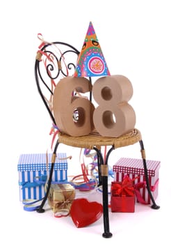 Number of age in a colorful studio setting with paper party hat and figures, a red heart and gifts