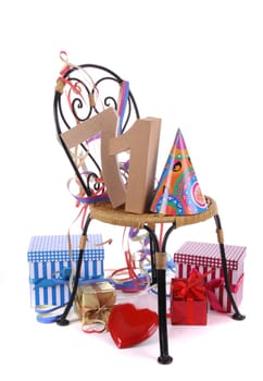 Number of age in a colorful studio setting with paper party hat and figures, a red heart and gifts