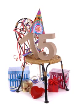 Number of age in a colorful studio setting with paper party hat and figures, a red heart and gifts