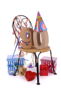 Number of age in a colorful studio setting with paper party hat and figures, a red heart and gifts