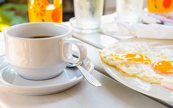 cup of coffee with breakfast fried egg
