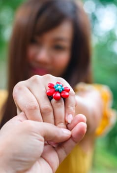 hand of man holds the young asian woman hand