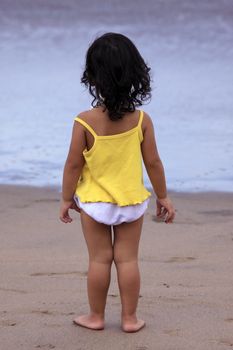 The small girl on a beach