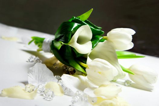 Wedding bouquet of white flowers on silver background