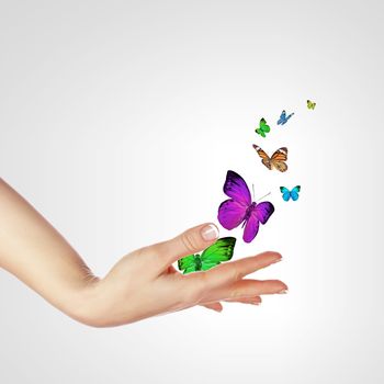 The Human hands releasing colourful butterflies illustration