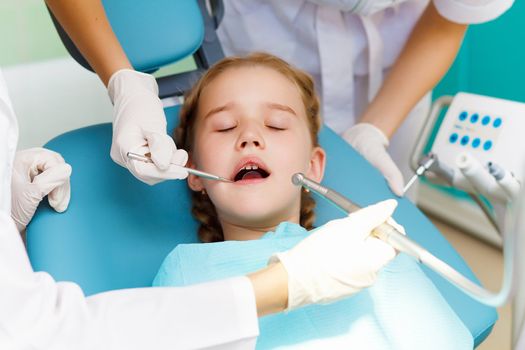 Little girl sitting in the dentists office