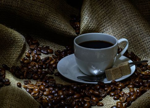 Coffee cup, beans and burlap. still life