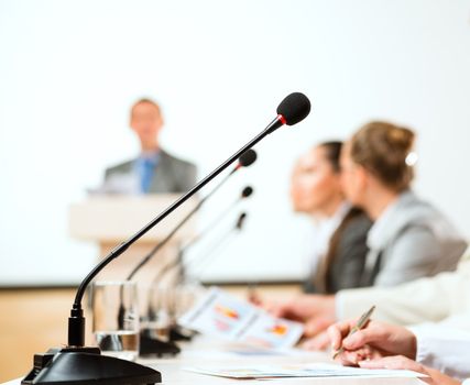 close-up microphone, on the background of business communication at the conference