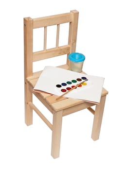 a little wooden chair with paints and brushes to paint isolated on white