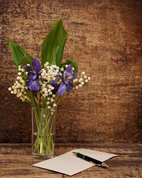 Still-life bouquet of lily of the valley  with blue irises