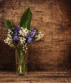 Still-life bouquet of lily of the valley  with blue irises 