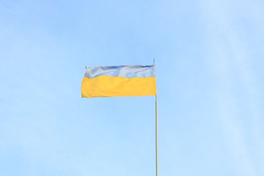 Ukrainian flag on a background of blue sky