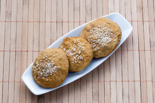 sweet cakes with sesame seeds on a plate