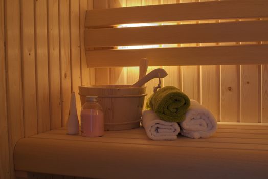 sauna interior with towels and wooden bucket