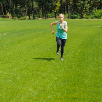 An active beautiful caucasian woman running outdoor in a park