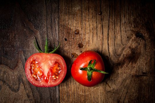 half tomato on brown textured wood