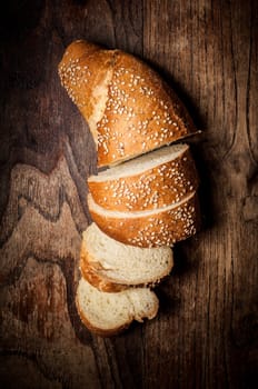 sliced wholemeal sesame bread on brown wood