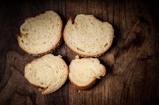 sliced wholemeal sesame bread on brown wood