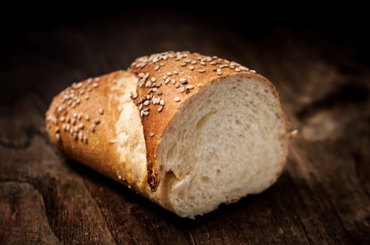 sliced wholemeal sesame bread on brown wood